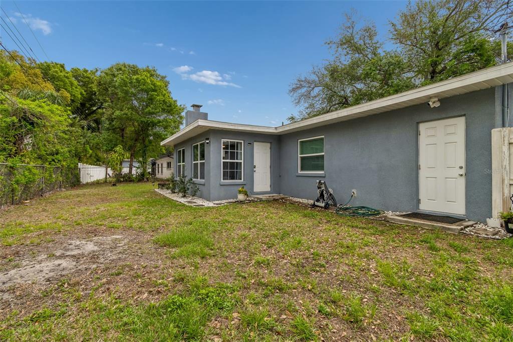 1618 Barry Road Clearwater, FL 33756 - Photo 62 of 71 a backyard of a house with table and chairs