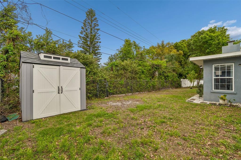 1618 Barry Road Clearwater, FL 33756 - Photo 63 of 71 a backyard of a house with yard and outdoor seating