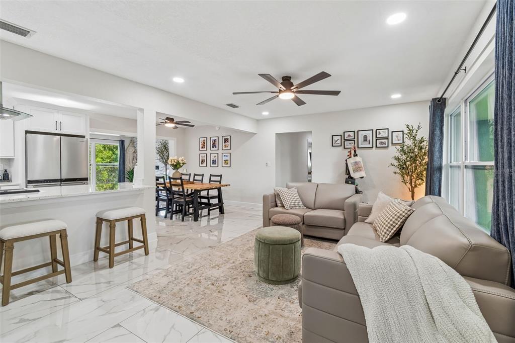 1618 Barry Road Clearwater, FL 33756 - Photo 10 of 71 a living room with furniture and a dining table with kitchen view