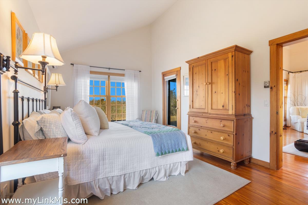 13 Eat Fire Spring Road Nantucket, MA 02554 - Photo 22 of 43 a bedroom with a bed and wooden floor