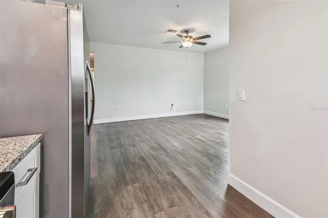 a view of an empty room with wooden floor