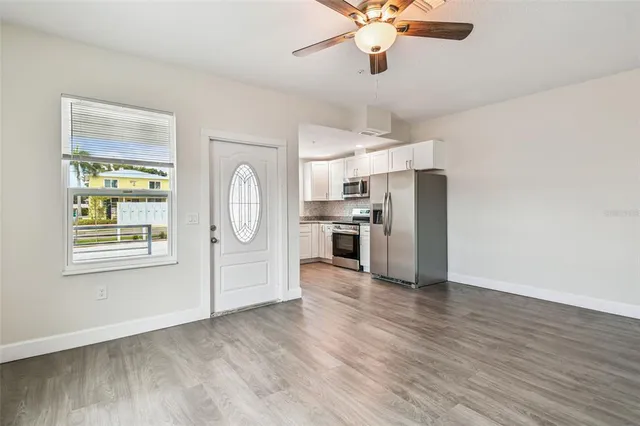 a view of kitchen with wooden floor electronic appliances and window