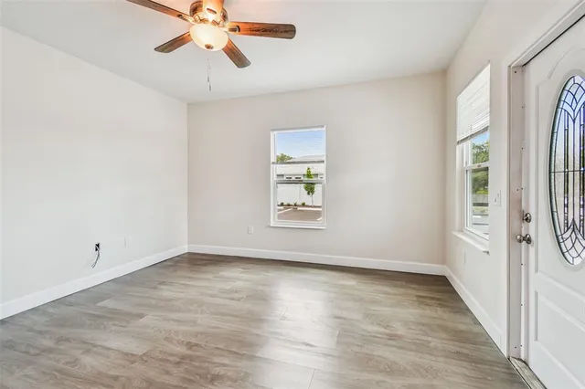 wooden floor in an empty room with a window