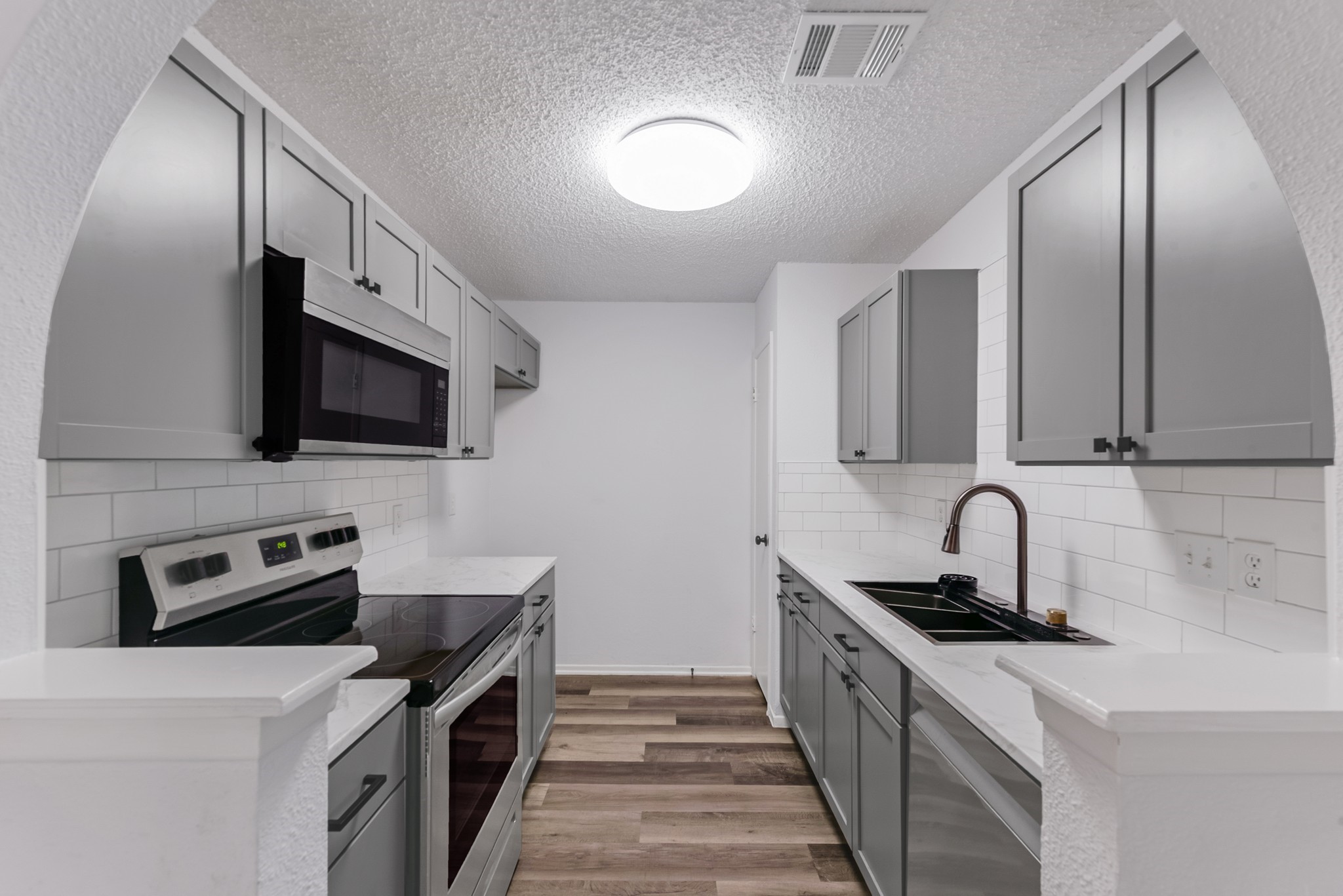 23426 Prairie Bird Drive Spring, TX 77373 - Photo 14 of 34 a kitchen with stainless steel appliances a stove microwave and sink