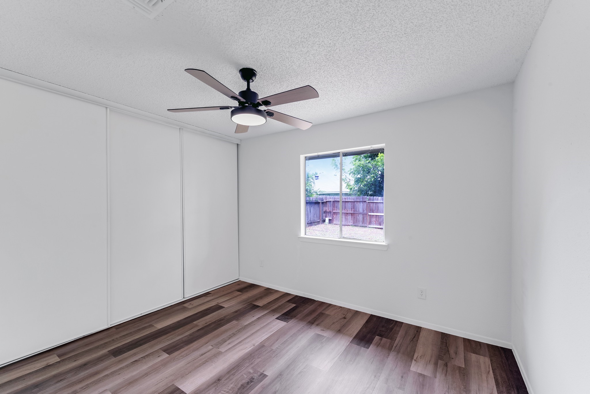 23426 Prairie Bird Drive Spring, TX 77373 - Photo 19 of 34 a view of an empty room with a window and wooden floor