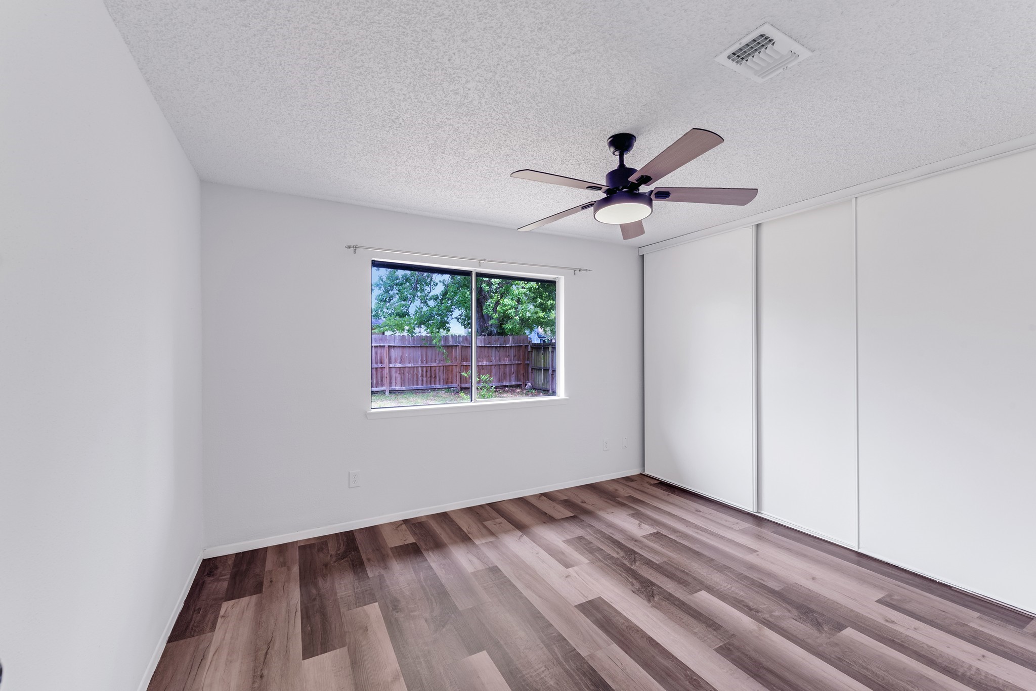 23426 Prairie Bird Drive Spring, TX 77373 - Photo 24 of 34 wooden floor in an empty room with a window