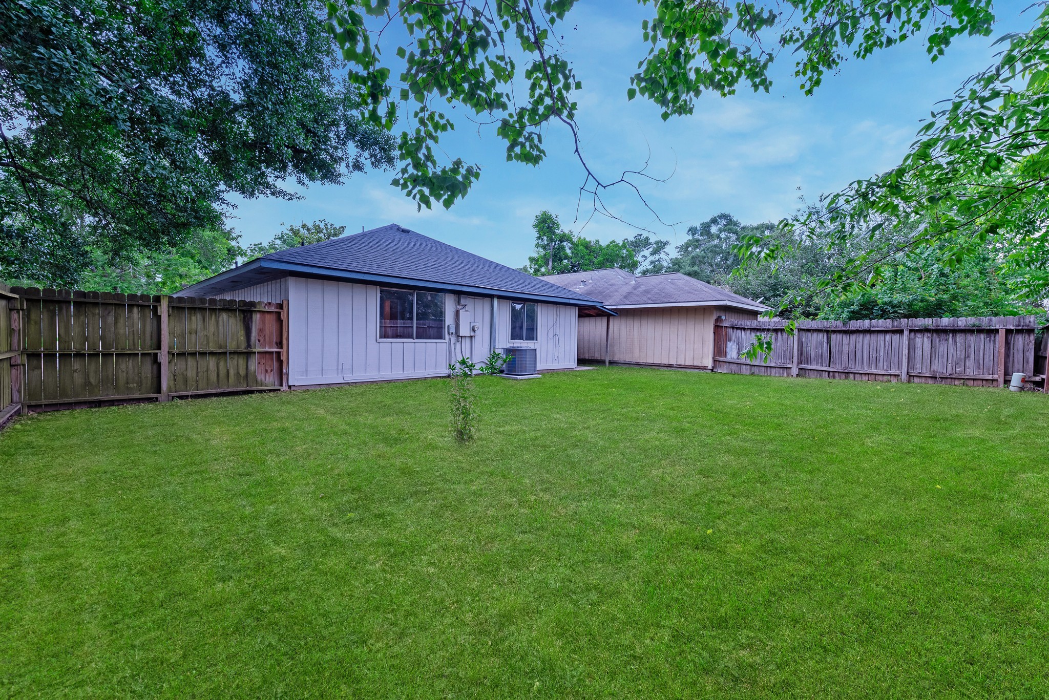 23426 Prairie Bird Drive Spring, TX 77373 - Photo 32 of 34 a view of a house with a yard plants and large tree