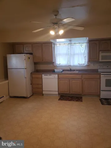 a kitchen with a refrigerator and a sink
