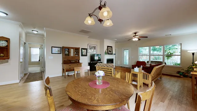 a living room with furniture and a baby crib