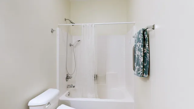 a balcony with a glass door and shower