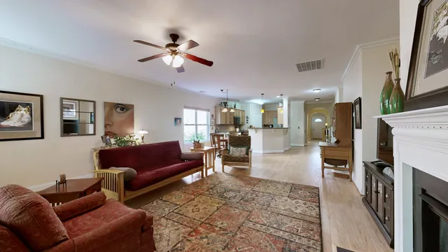 a living room with furniture ceiling fan and a window