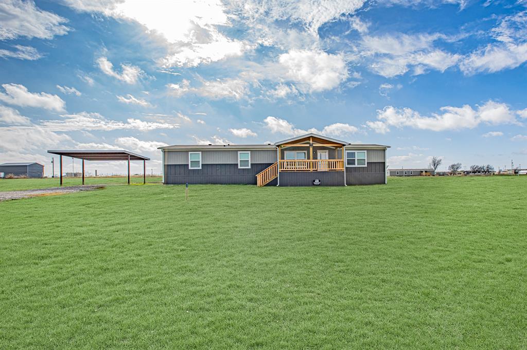 233 El Dorado Street Decatur, TX 76234 - Photo 1 of 1 Front view with AI generated lawn