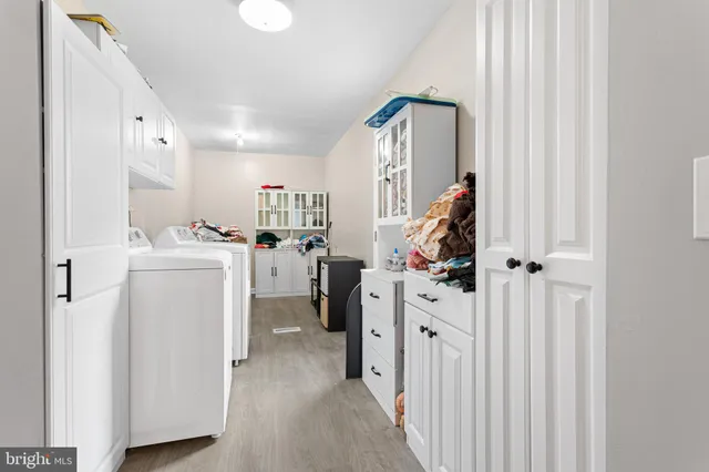 a view of a storage & utility room with closet dryer