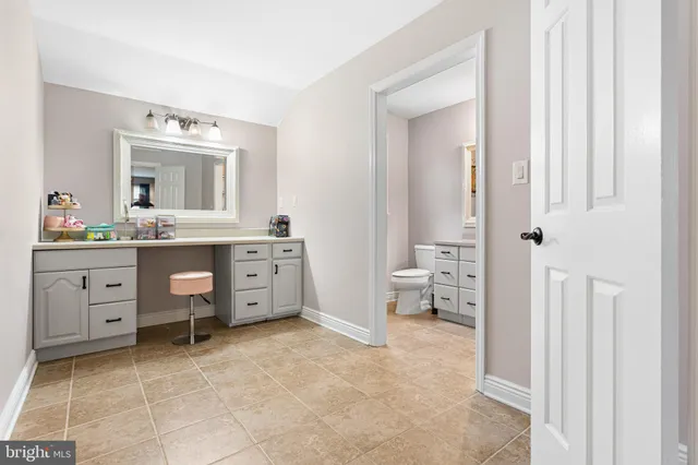 a view of a bathroom with a sink mirror and window