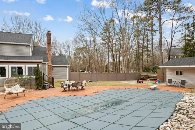 a view of a yard with swimming pool and sitting area