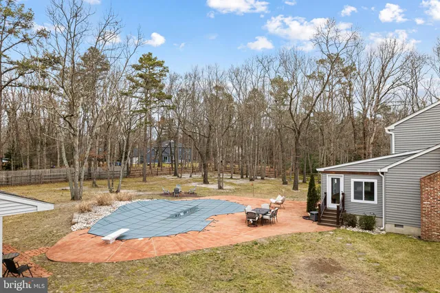 a view of a white house with a patio