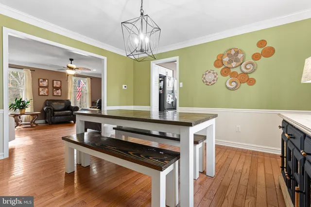 a kitchen with stainless steel appliances granite countertop a stove and a wooden floor