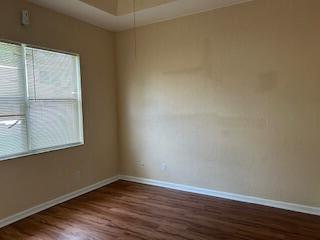 5642 Sunberry Circle Fort Pierce, FL 34951 - Photo 4 of 11 a view of an empty room with wooden floor and a window