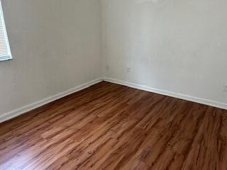 5642 Sunberry Circle Fort Pierce, FL 34951 - Photo 7 of 11 a view of an empty room with wooden floor and a window