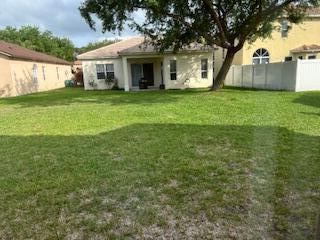 5642 Sunberry Circle Fort Pierce, FL 34951 - Photo 10 of 11 a view of a house with a yard
