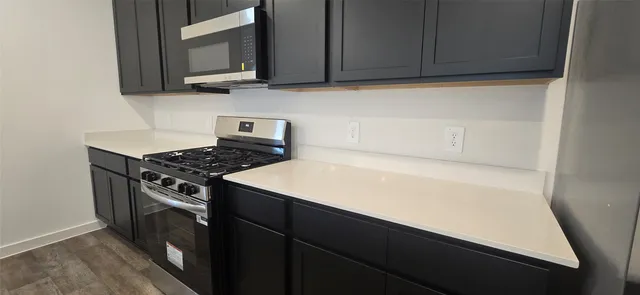 a kitchen with a stove and a microwave