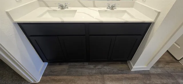 a close view of a sink a refrigerator and a microwave in a kitchen