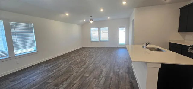 a view of a room with wooden floor and cabinet