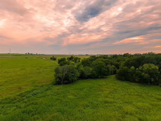 a view of a green field with clear sky