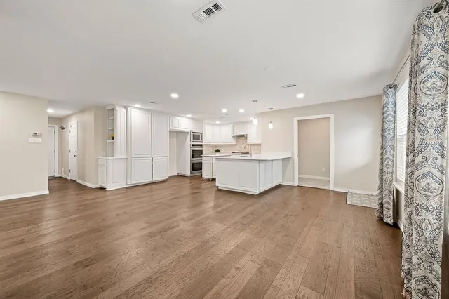 a view of a kitchen with a sink and a refrigerator