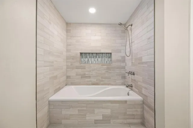 a bath tub sitting next to a shower