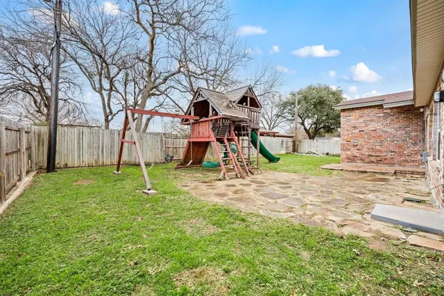 a view of outdoor space with playground and green space