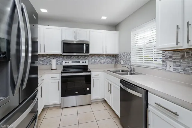 a kitchen with a sink stove and refrigerator
