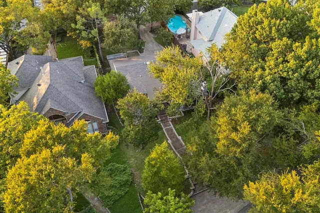 front view of a house with a yard and potted plants