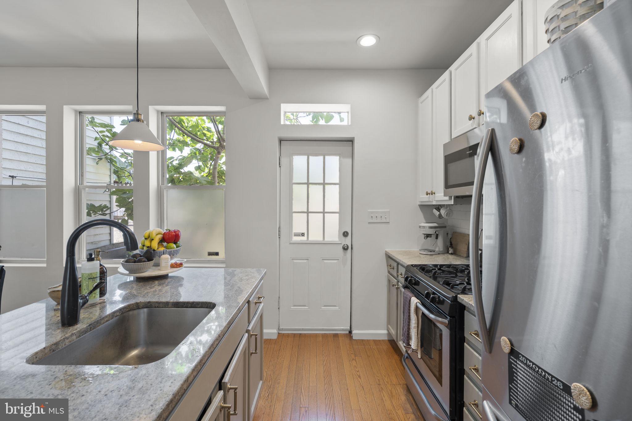 1712 M Street Northeast Washington, DC 20002 - Photo 3 of 38 a kitchen with stainless steel appliances granite countertop a sink stove and refrigerator