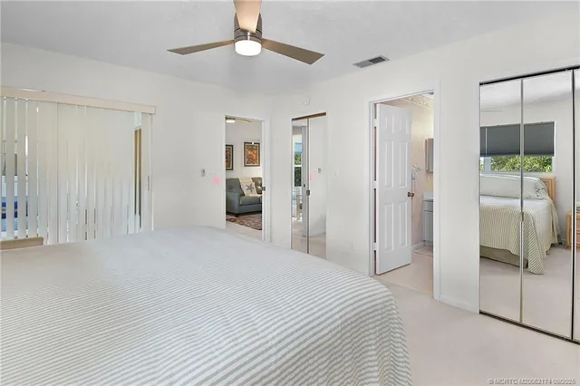 a large bedroom with a bed and a chandelier