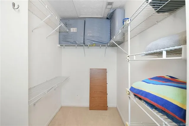 a view of walk in closet with empty racks