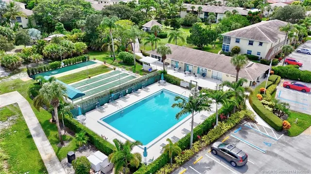 an aerial view of a house with a garden and swimming pool