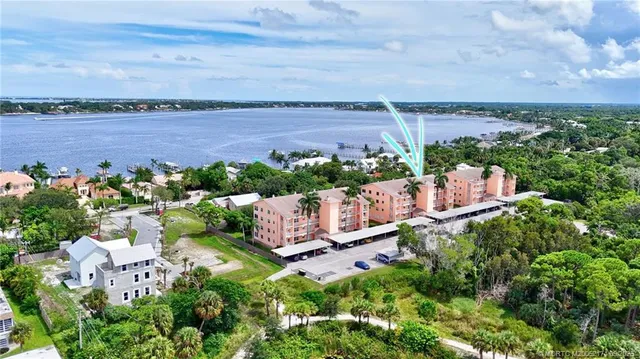 an aerial view of a house with a garden and lake view