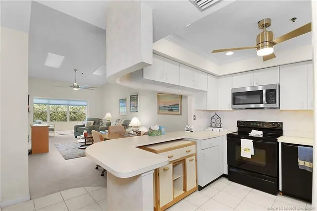 a kitchen that has a lot of cabinets in it and appliances