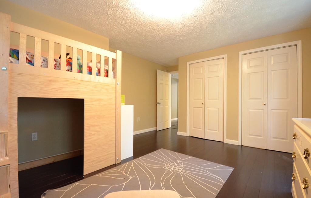 335 Littleton Road Harvard, MA 01451 - Photo 15 of 24 a bedroom with a bed and wooden floor