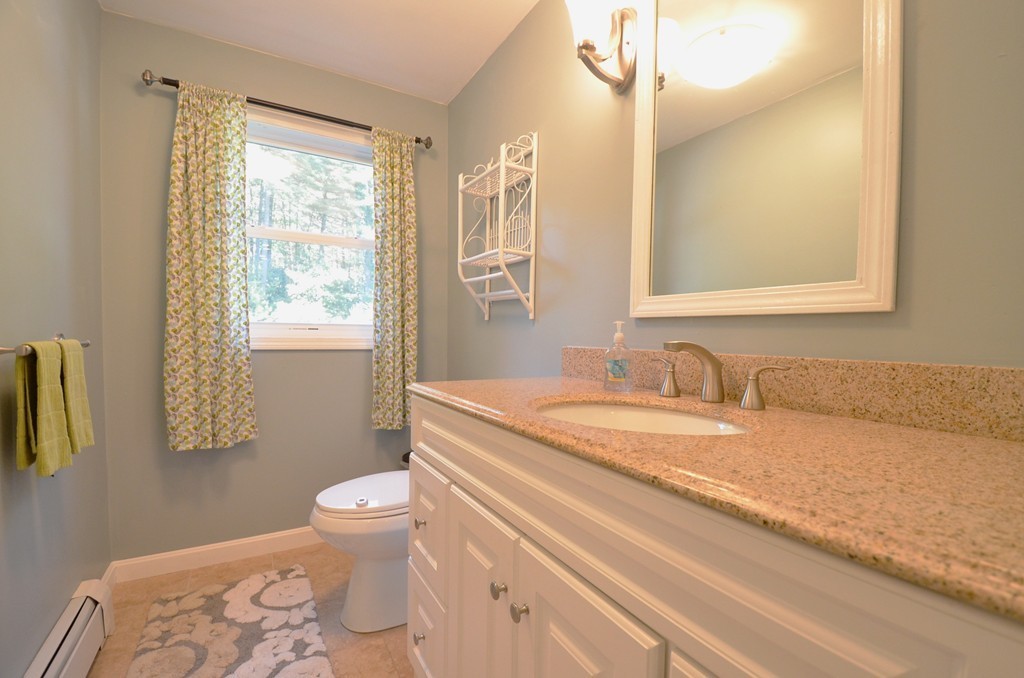 335 Littleton Road Harvard, MA 01451 - Photo 6 of 24 a bathroom with a granite countertop sink mirror vanity and toilet