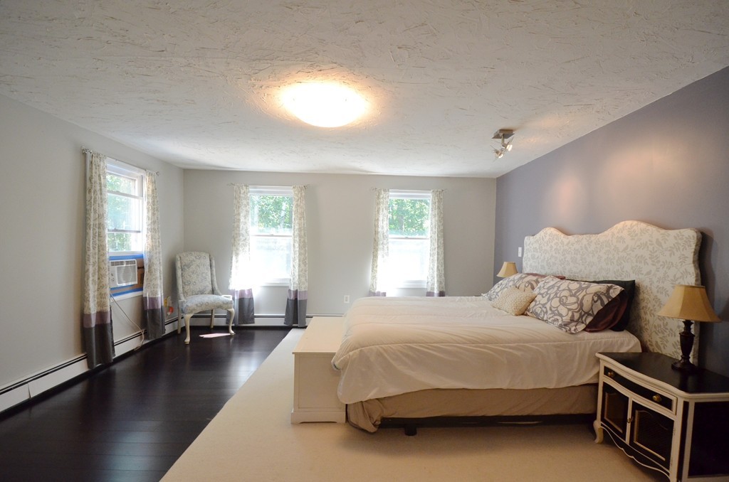 335 Littleton Road Harvard, MA 01451 - Photo 10 of 24 a bedroom with a bed and a chandelier