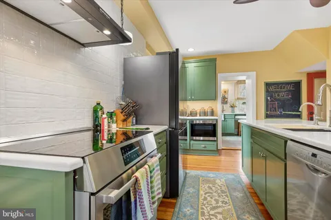 a kitchen with stainless steel appliances granite countertop a sink and cabinets