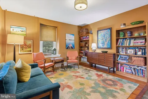 a living room with furniture and a dining table