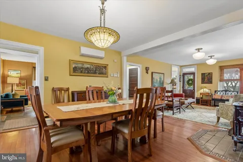 a view of a dining room with furniture wooden floor and chandelier