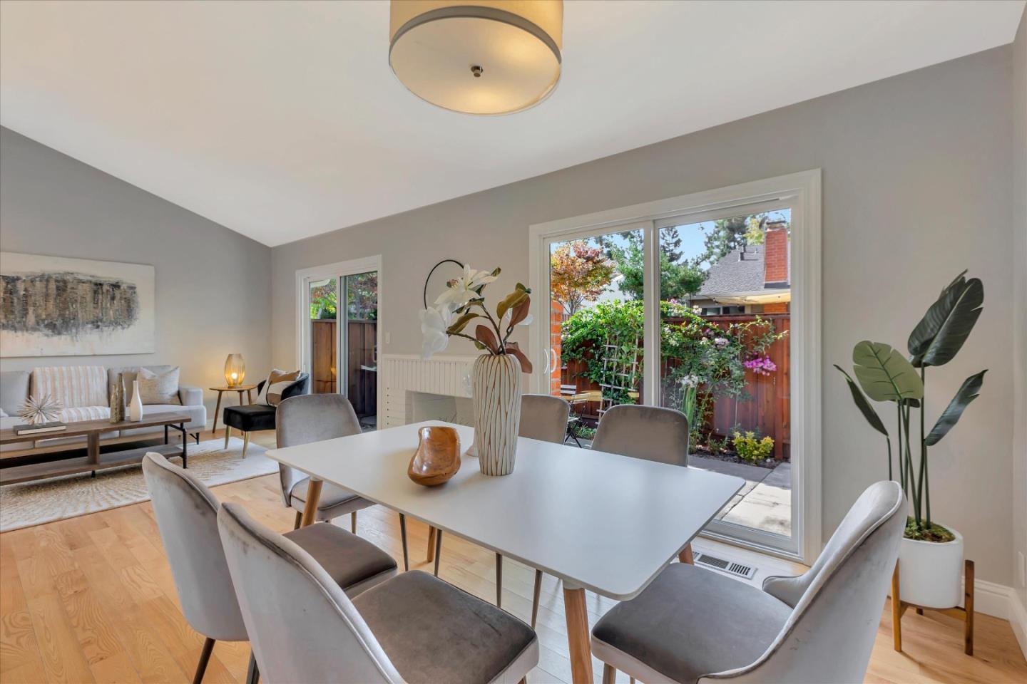 10961 Northsky Square Cupertino, CA 95014 - Photo 16 of 50 a view of a dining room with furniture a potted plant and a floor to ceiling window