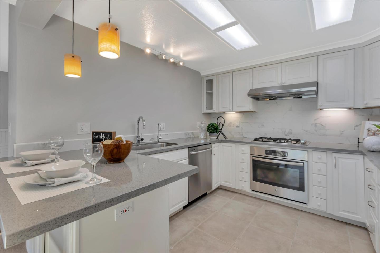 10961 Northsky Square Cupertino, CA 95014 - Photo 9 of 50 a kitchen with stove a sink and cabinets