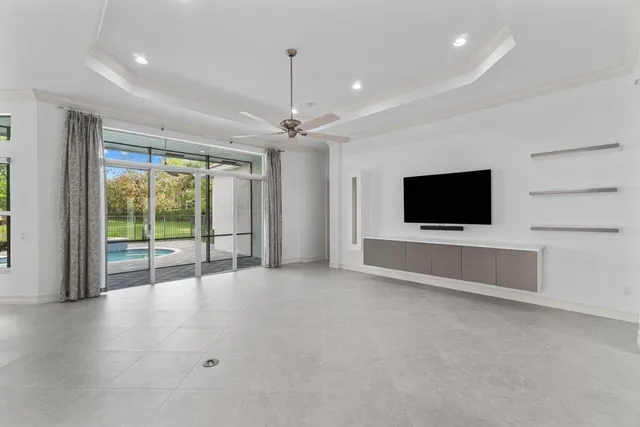a view of an empty room with a flat screen tv and outdoor view