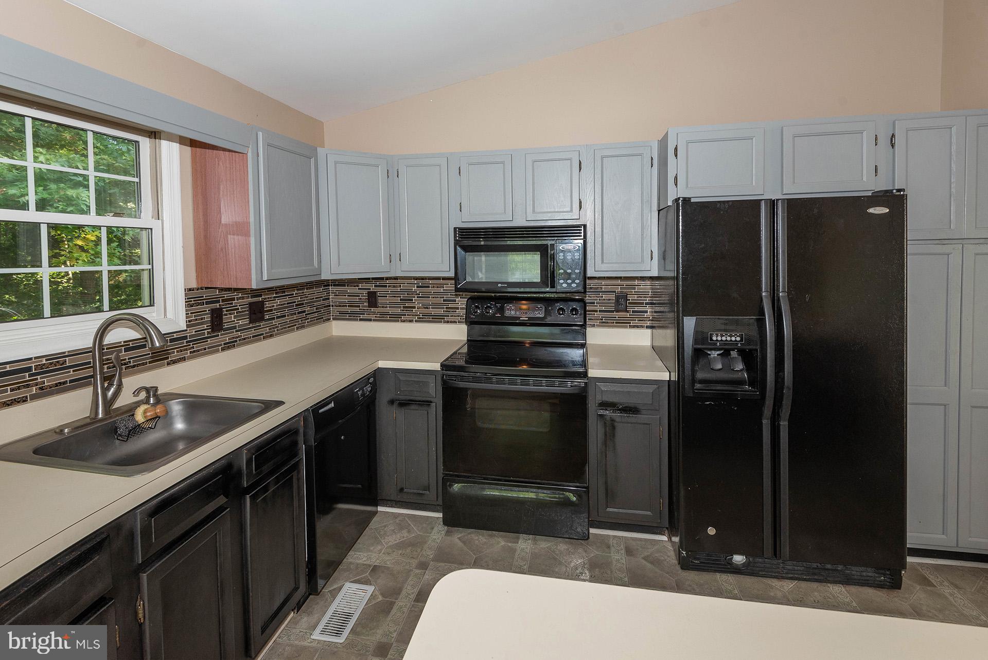 7523 Harmans Road Harmans, MD 21077 - Photo 7 of 27 a kitchen with a sink appliances and cabinets
