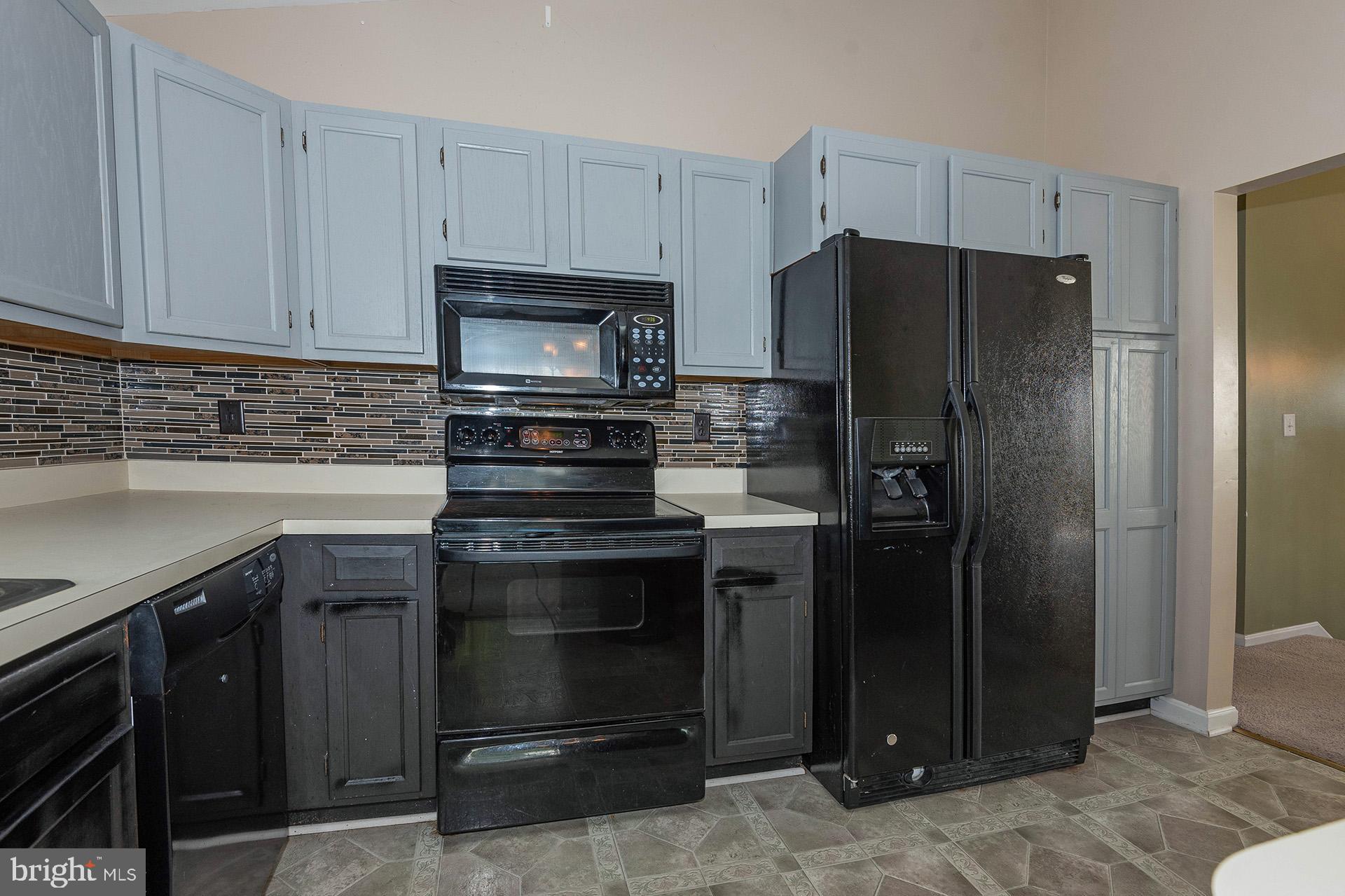 7523 Harmans Road Harmans, MD 21077 - Photo 8 of 27 a kitchen with a refrigerator stove and cabinets